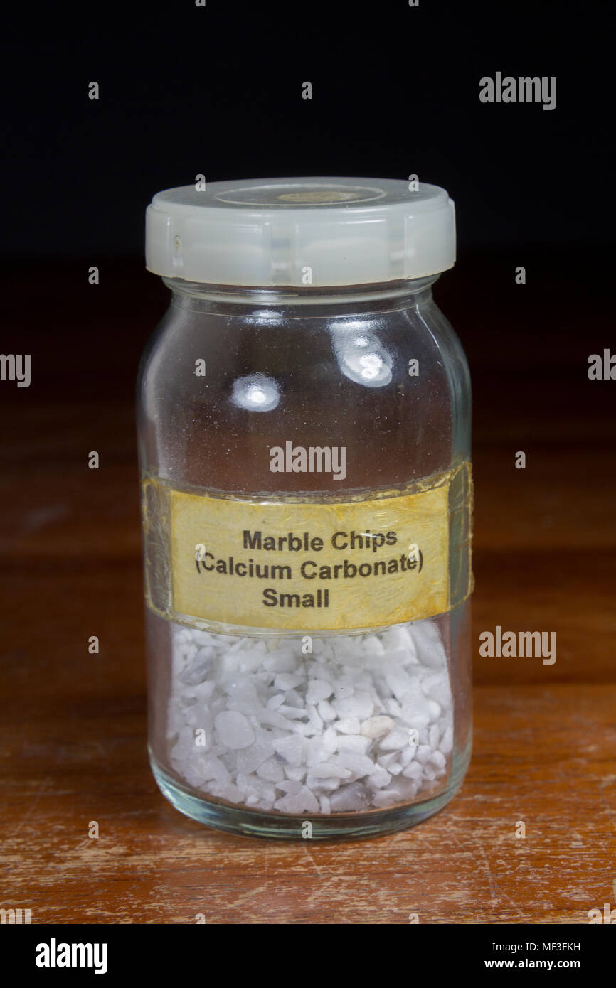 A jar of small calcium carbonate (marble) chips as used in a UK secondary/high school. Stock Photo