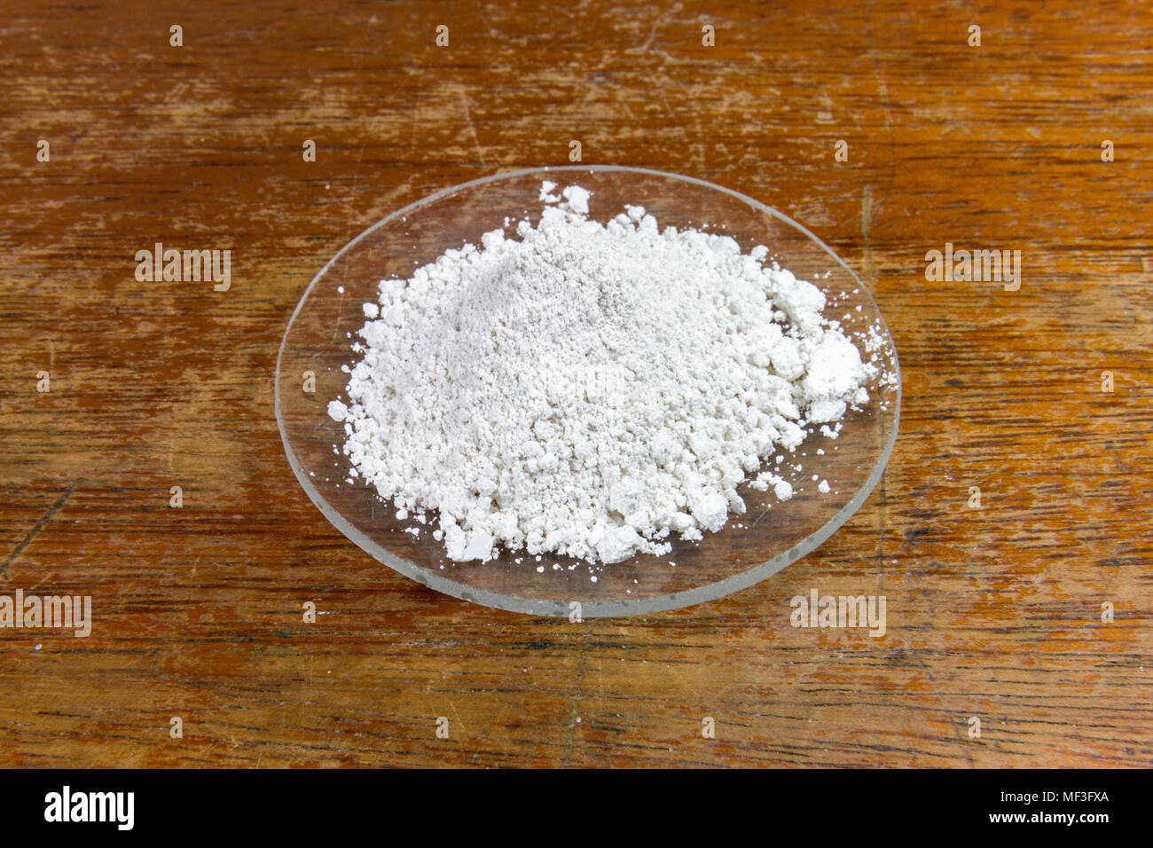 A watch glass of calcium carbonate as used in a UK Secondary/High school. Stock Photo