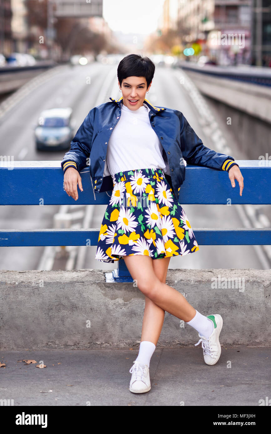 Portrait of fashionable young woman wearing skirt with floral design Stock Photo