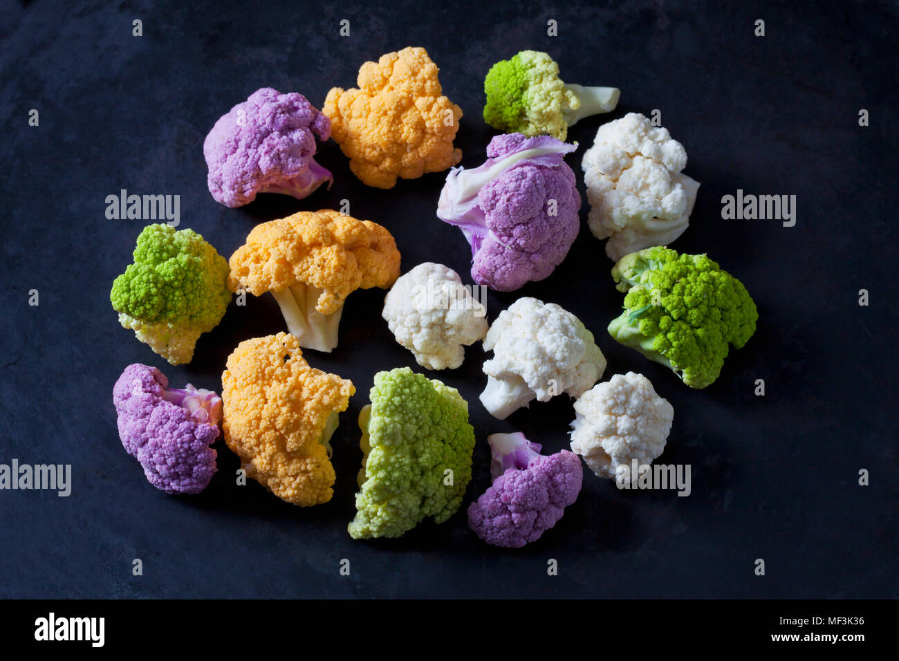 Coloured cauliflower florets on dark background Stock Photo