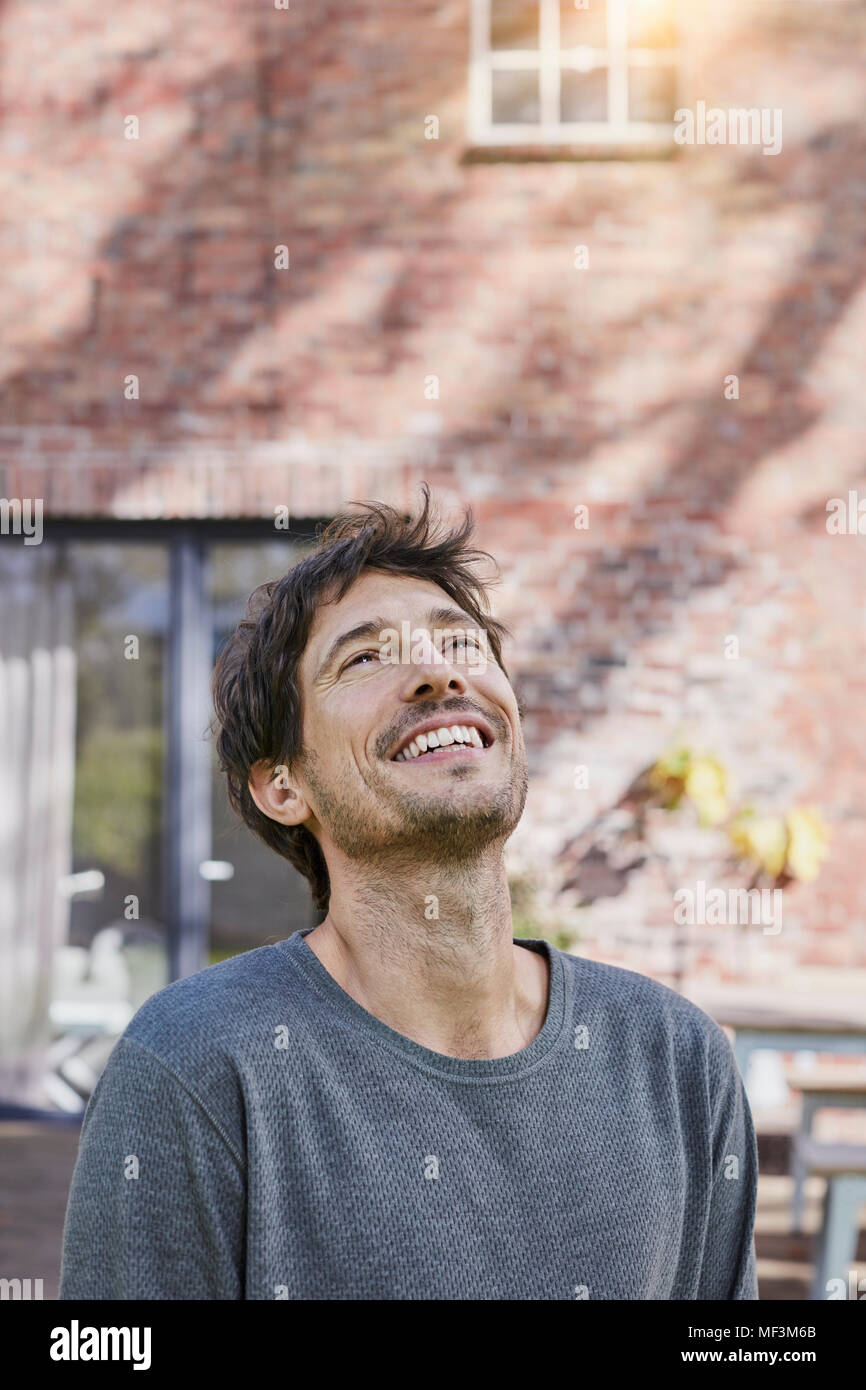 Portrait of happy man in front of his home Stock Photo