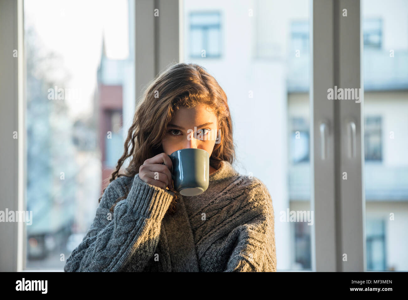 Portrait of teenage girl drinking coffee at home Stock Photo