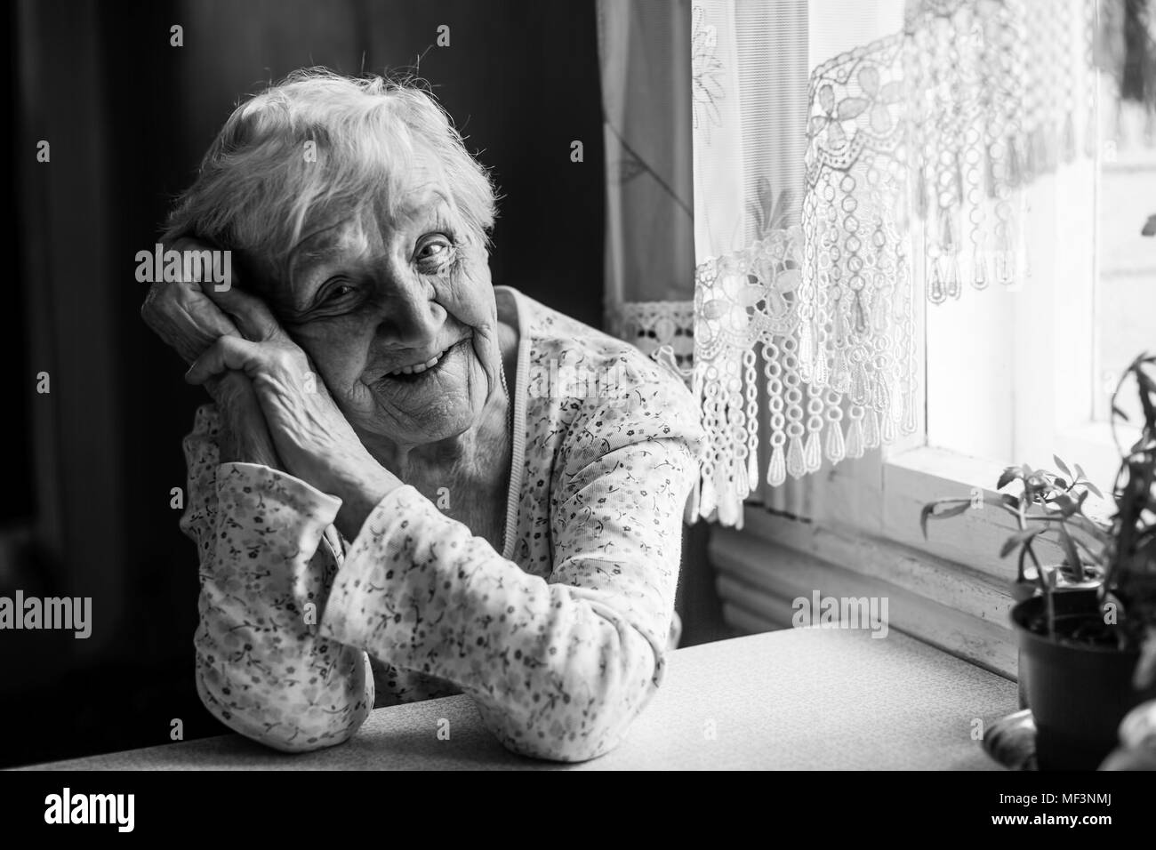 Black and white portrait of an elderly positive woman 75-80 years old. Stock Photo