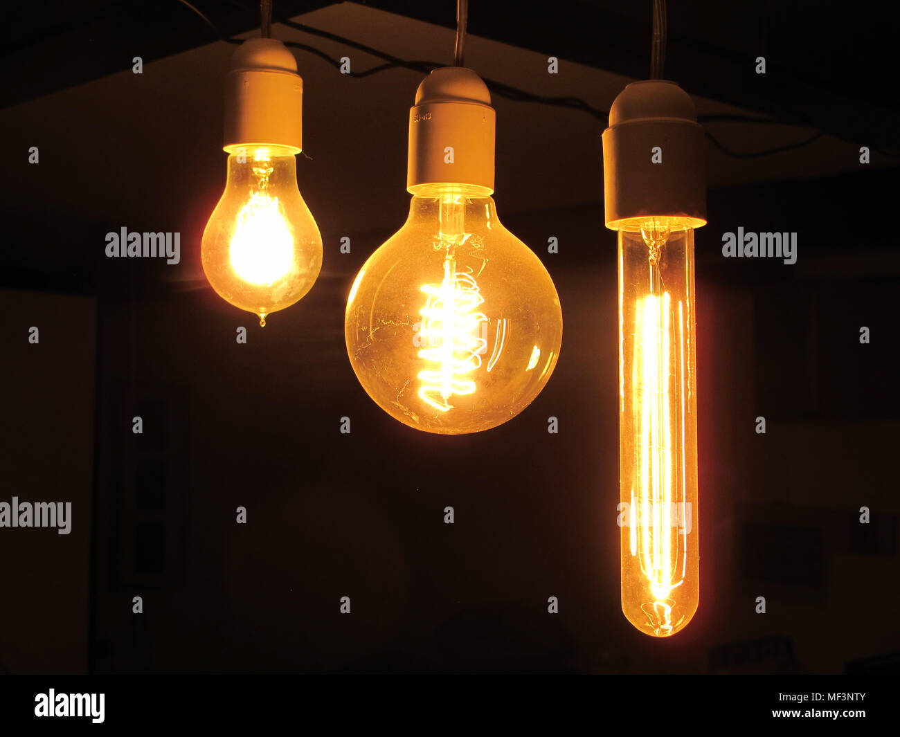 Filaments glowing in vintage light bulbs Stock Photo