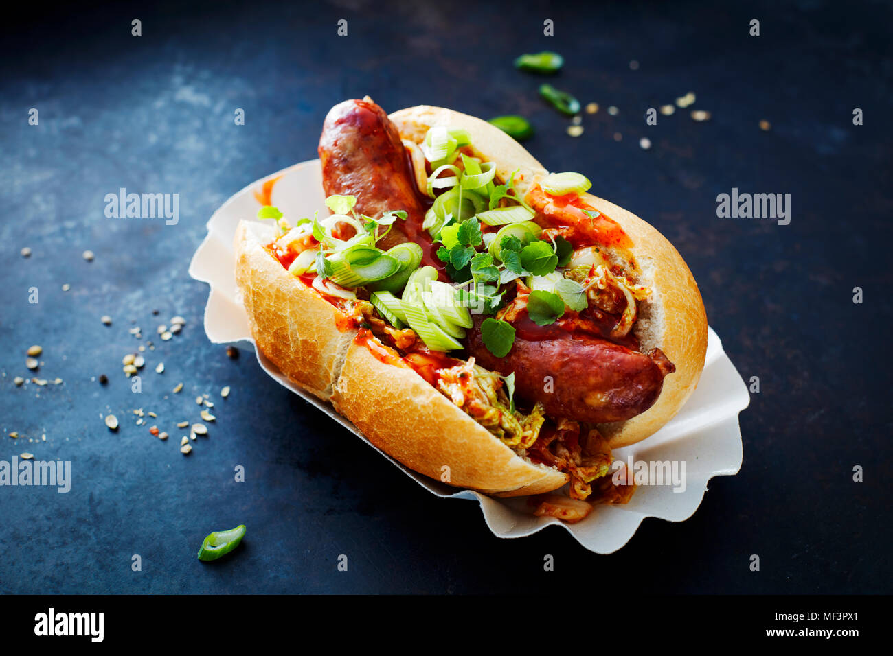 Asian hot dog, fried sausage, spicy chinese cabbage, hot chili sauce