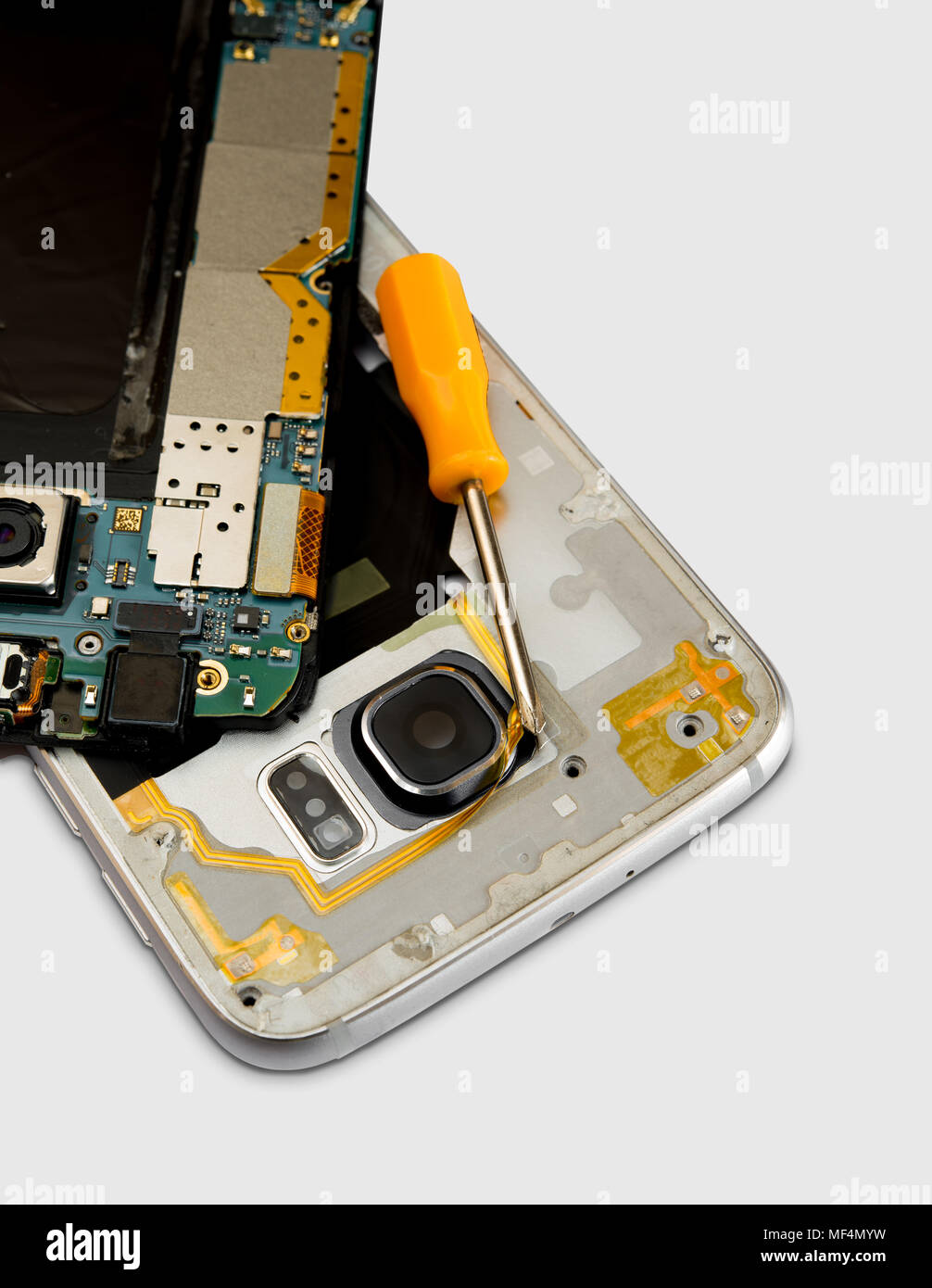 Broken cell phone  with small screwdriver on white background Stock Photo