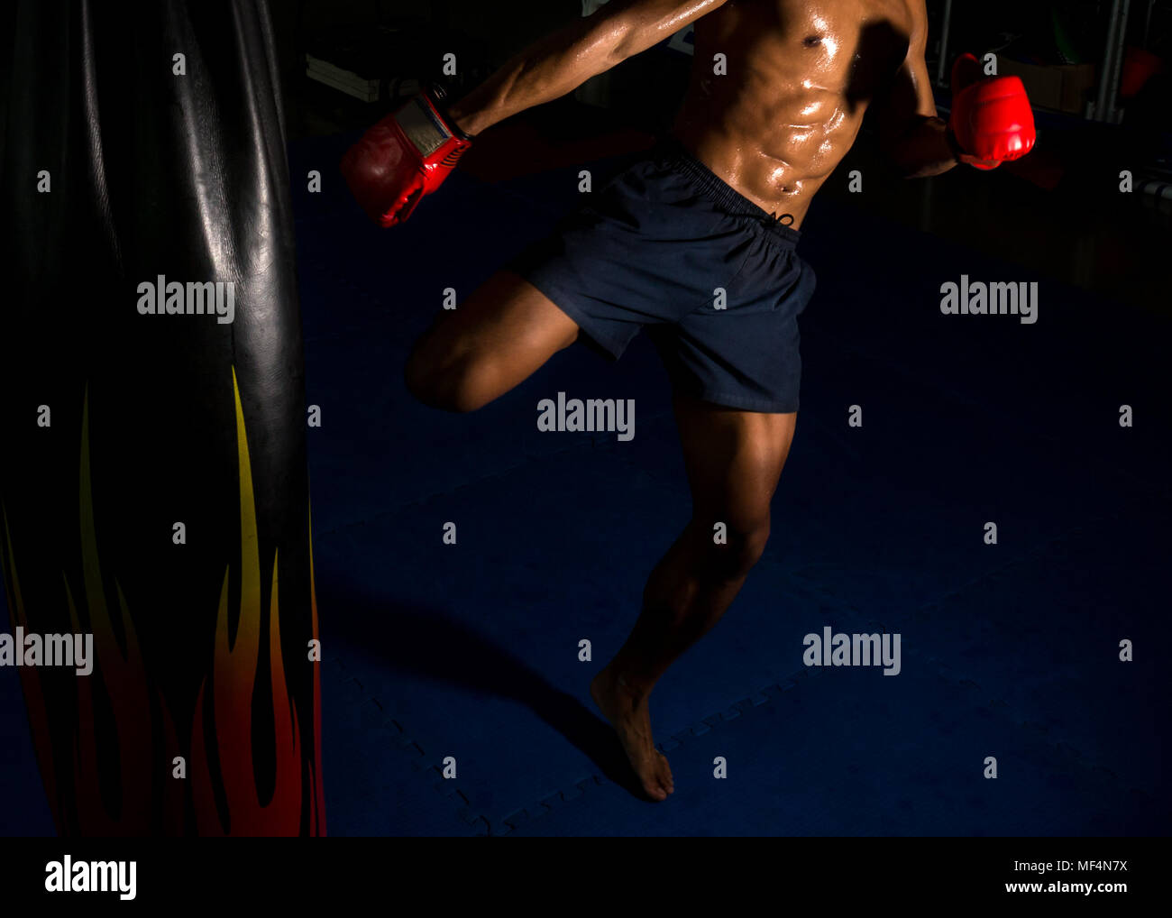 boxer kick at the target on boxing ring in gym, Thai boxing which is the famous sport in Thailand Stock Photo