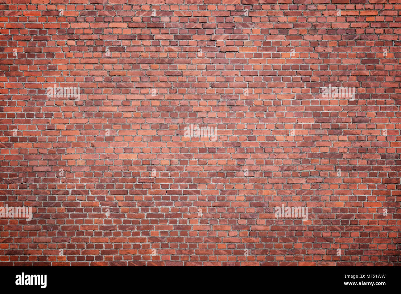 Big full frame background of detailed old red brick wall with vignette. Copy space. Stock Photo