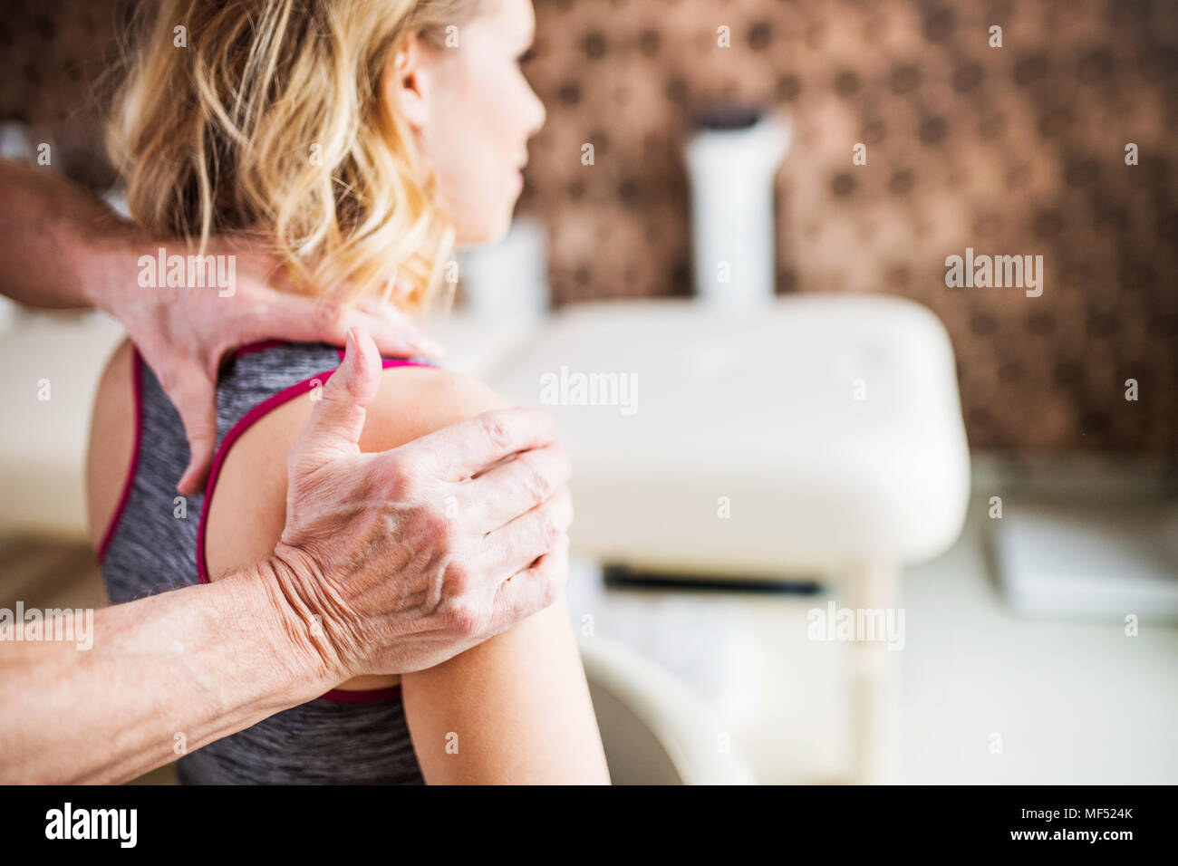 Unrecognizable physiotherapist working with a female patient. Stock Photo