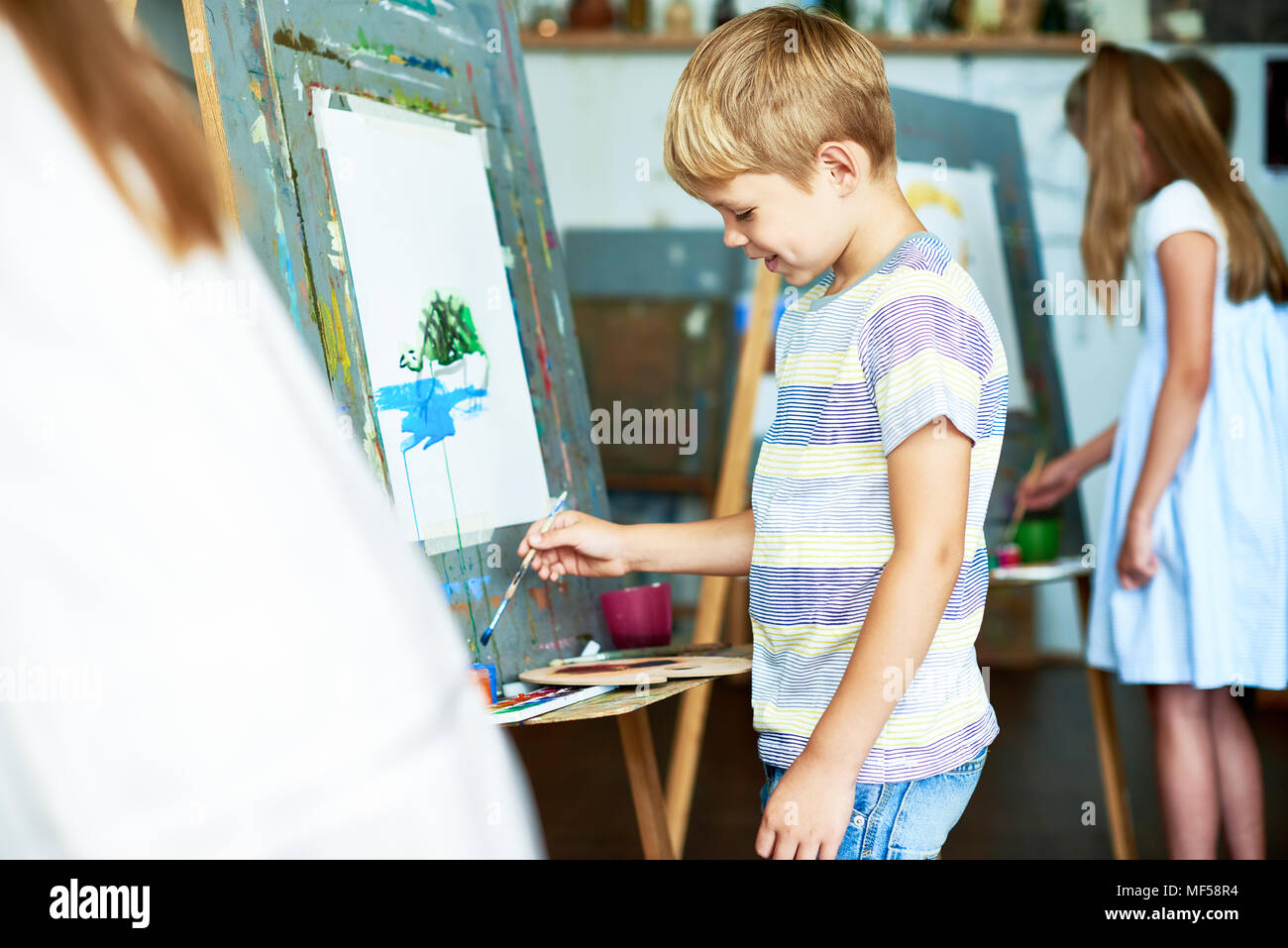 Little Boy Painting Picture in School Stock Photo