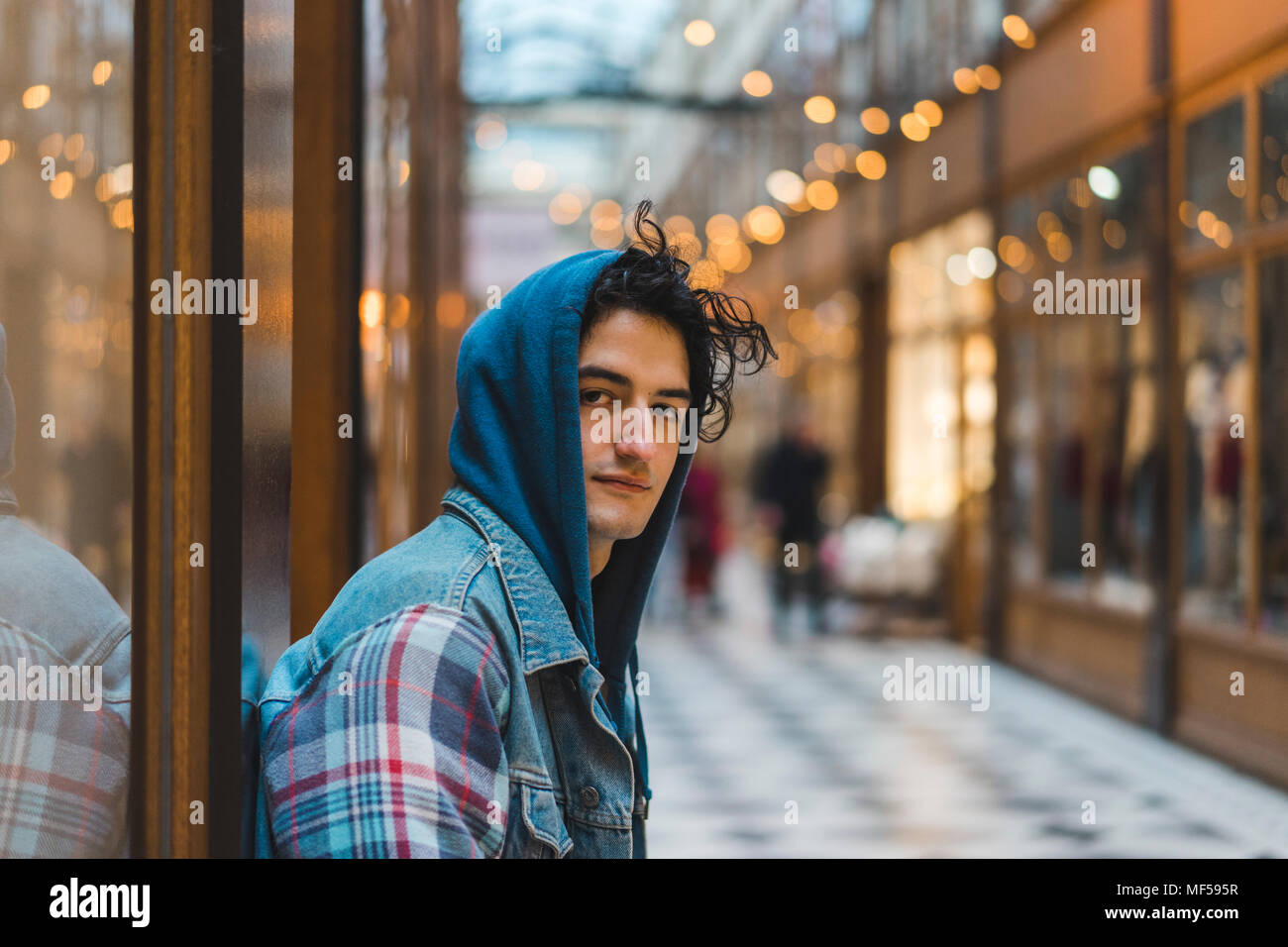 Portrait of young man in shopping centre Stock Photo - Alamy