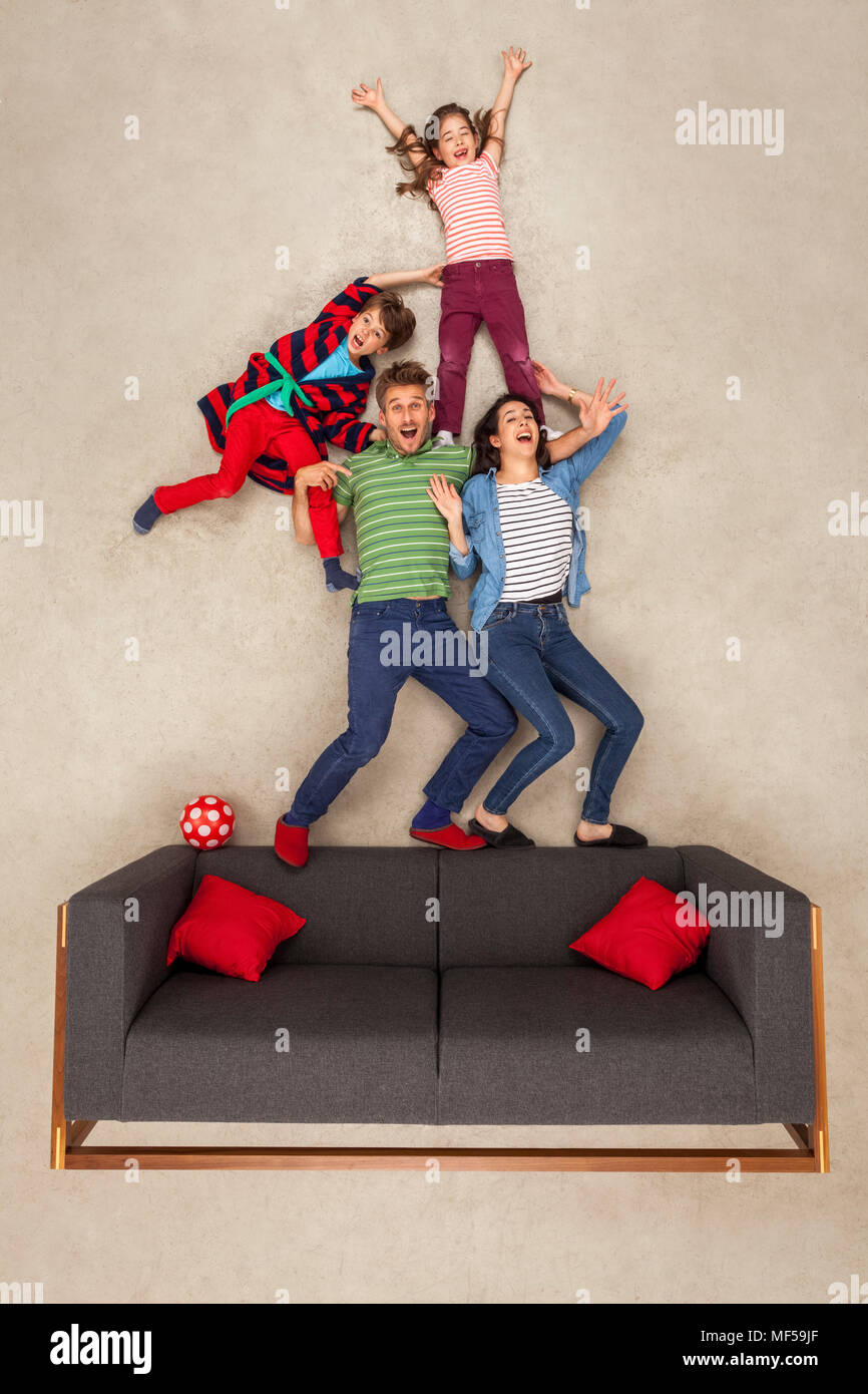 Happy family at home on couch Stock Photo