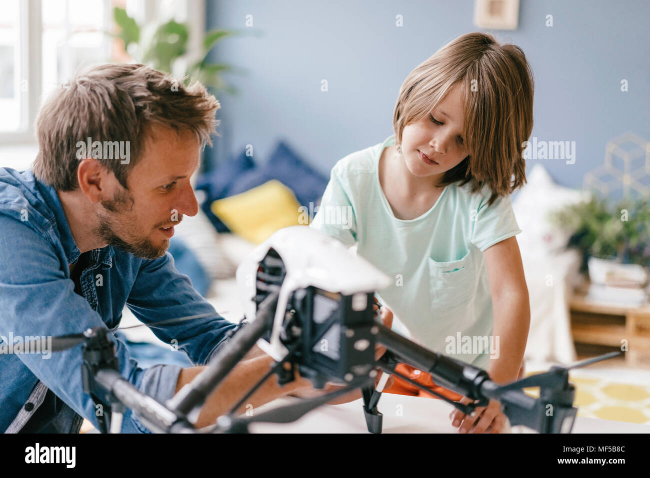 Father and son with drone at home Stock Photo - Alamy