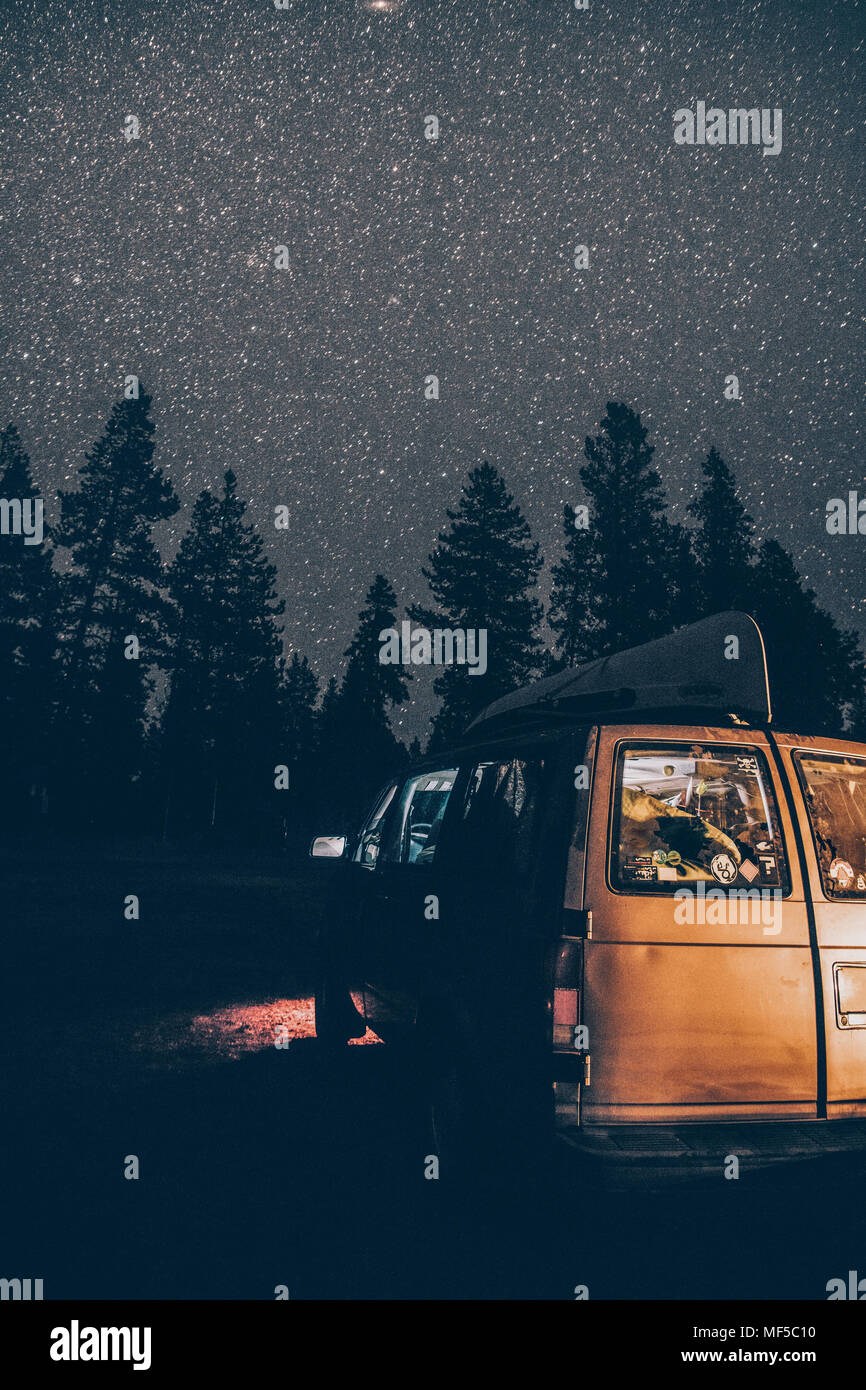 Canada, British Columbia, Chilliwack, starry sky and illuminated minivan at night Stock Photo