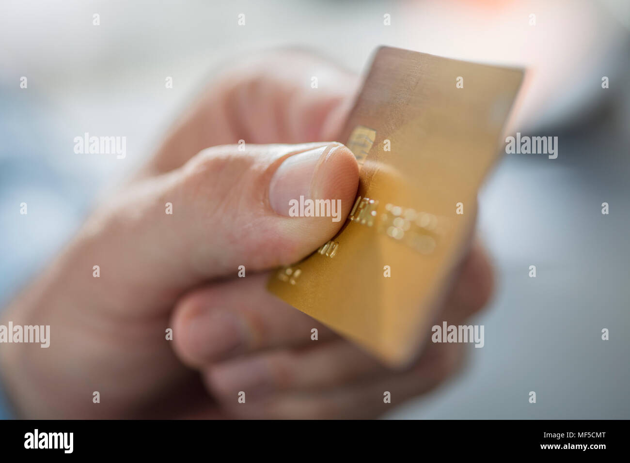 Man's hand holding credit card, close-up Stock Photo