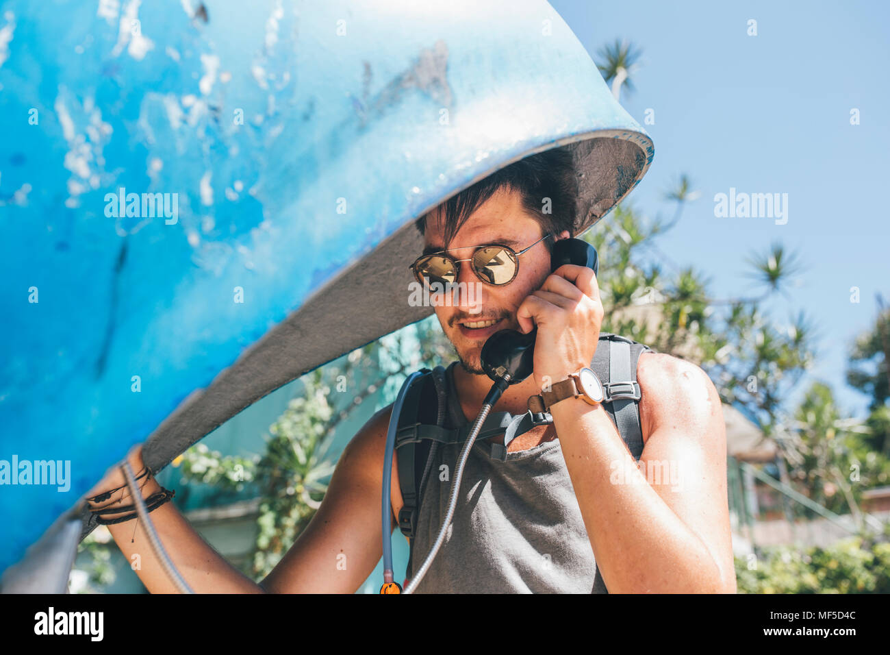 Cuba, Young man amking a call from a telephone booth Stock Photo