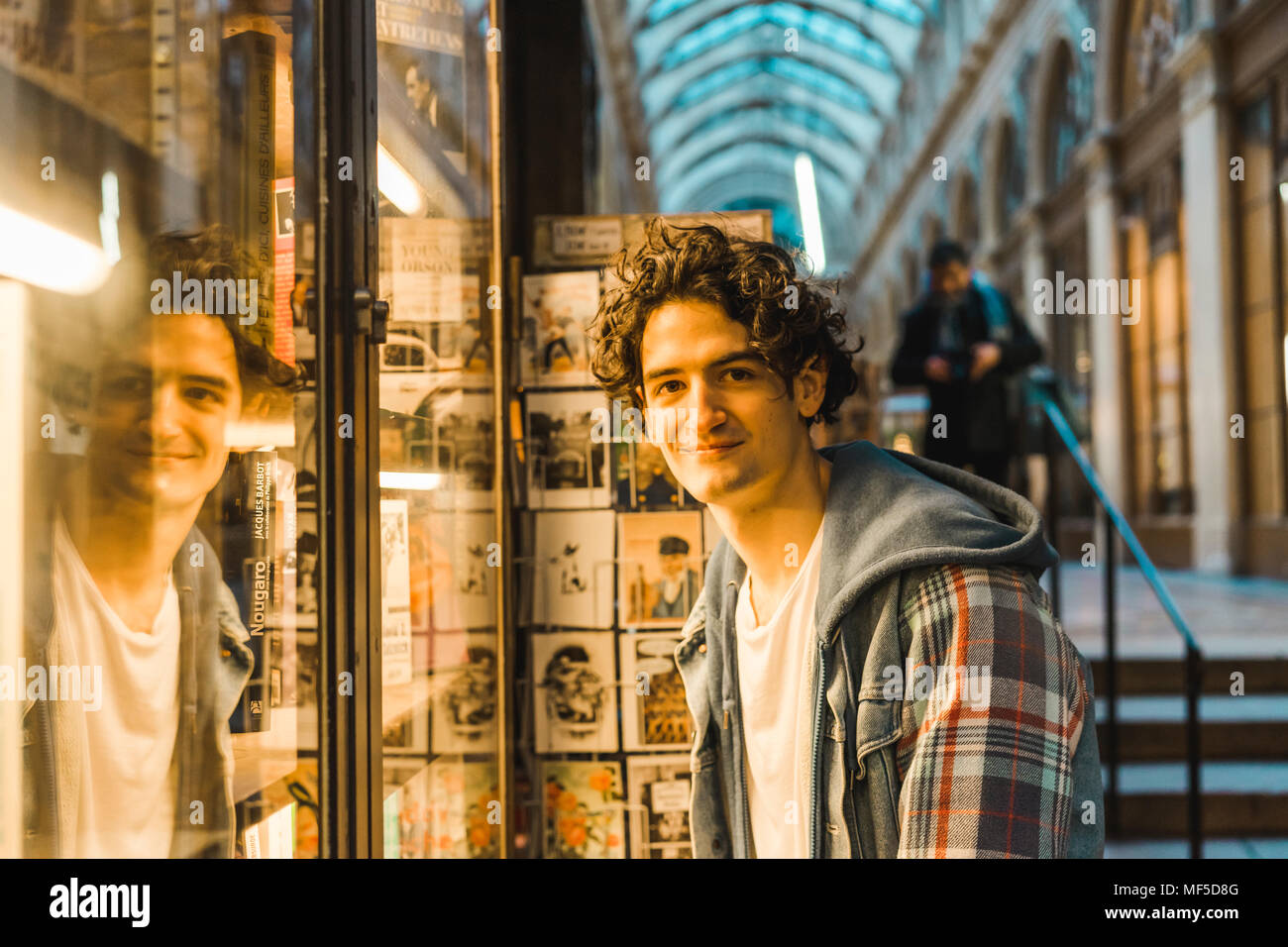 Portrait of smiling young man in shopping centre Stock Photo - Alamy