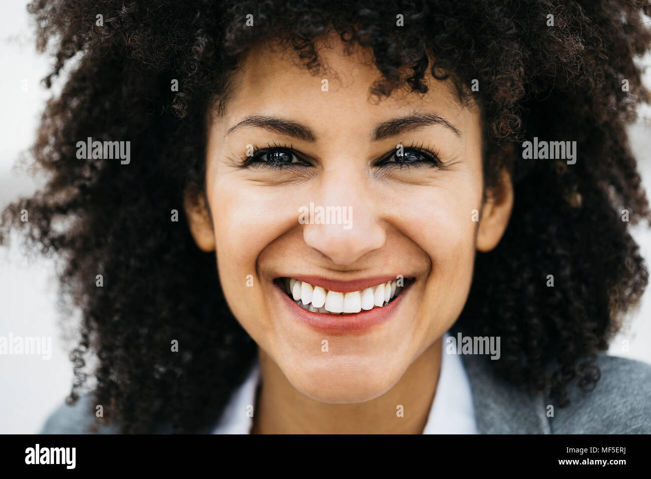 Portrait of happy woman with curly hair Stock Photo