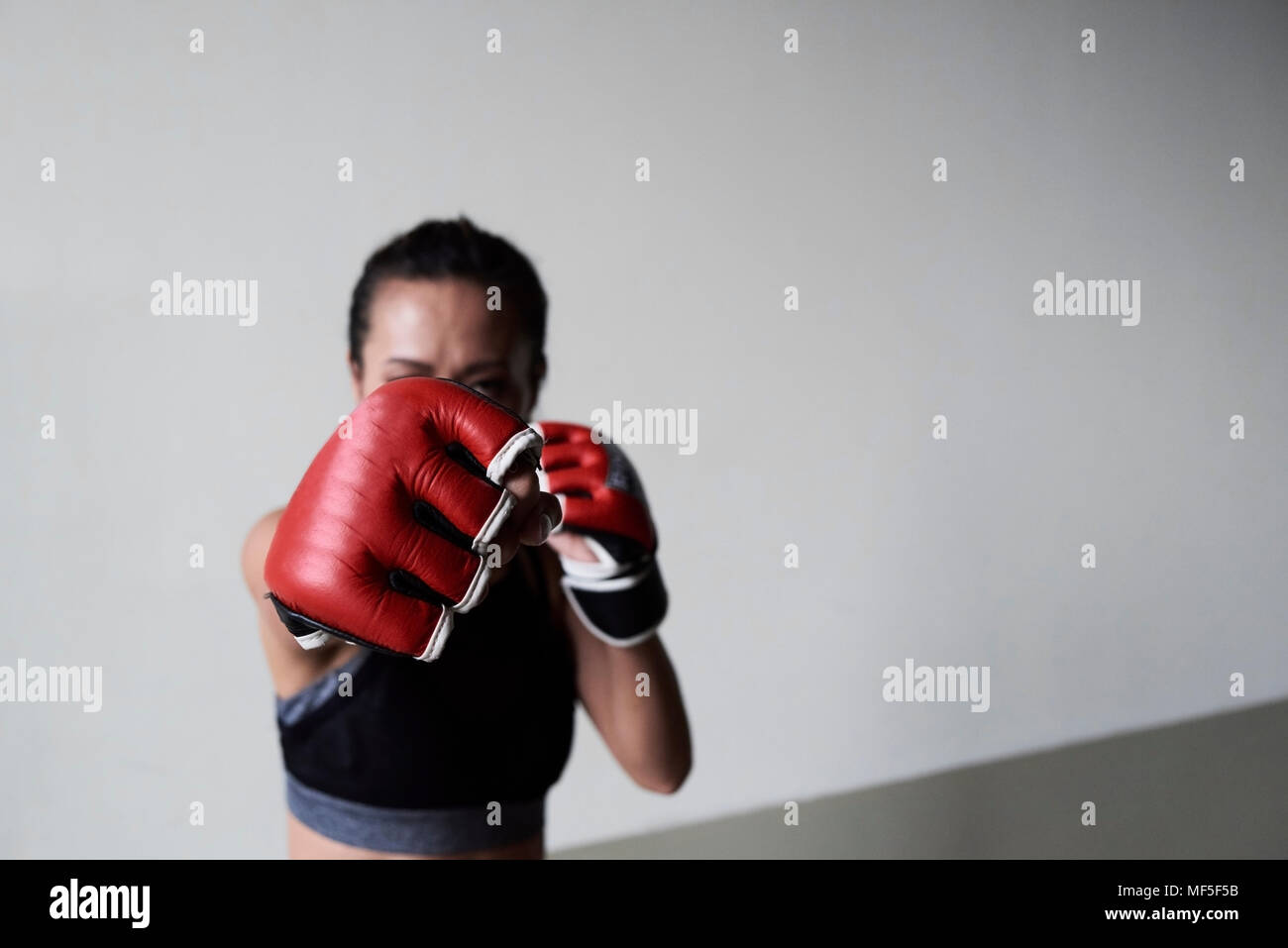 Boxing glove of a female boxer exercising Stock Photo