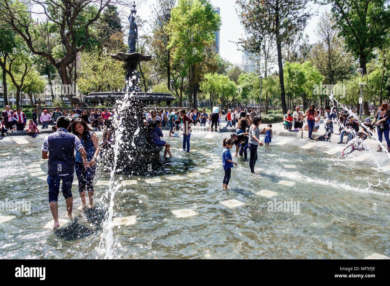 Mexico City,Mexican,Hispanic Latin Latino ethnic,historic Center Centre,Central Park Alameda,public urban park,fountain,crowd,water,children, Stock Photo