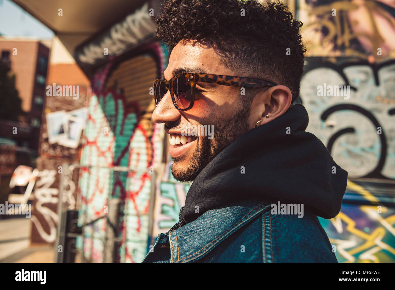 Portrait of smiling stylish young man outdoors Stock Photo - Alamy