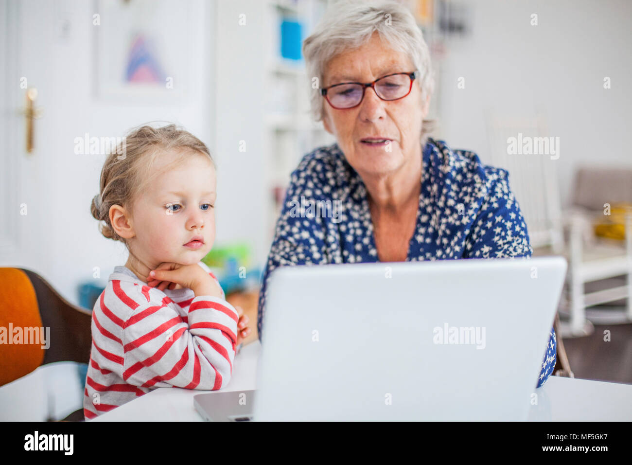 Grandmother and granddaughter using laptop Stock Photo - Alamy