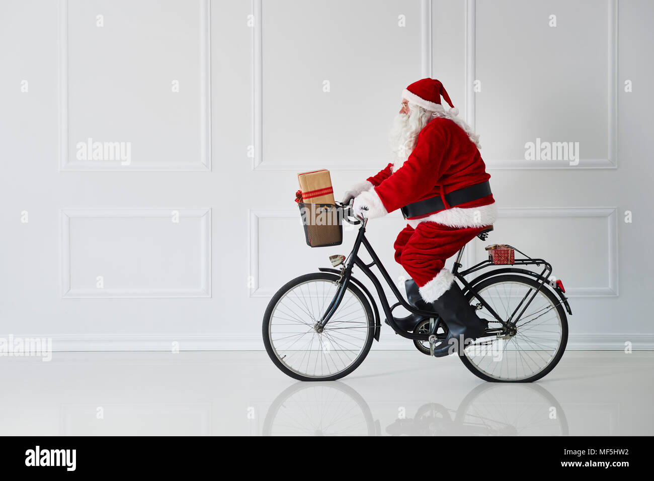 Santa Claus riding a bike Stock Photo