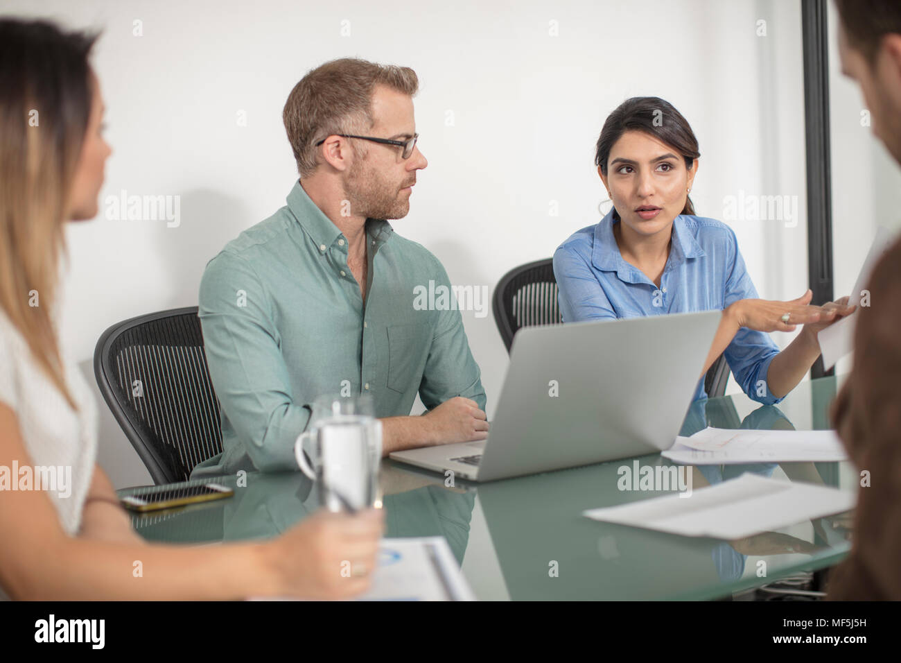 Colleagues having a meeting in office boardroom Stock Photo