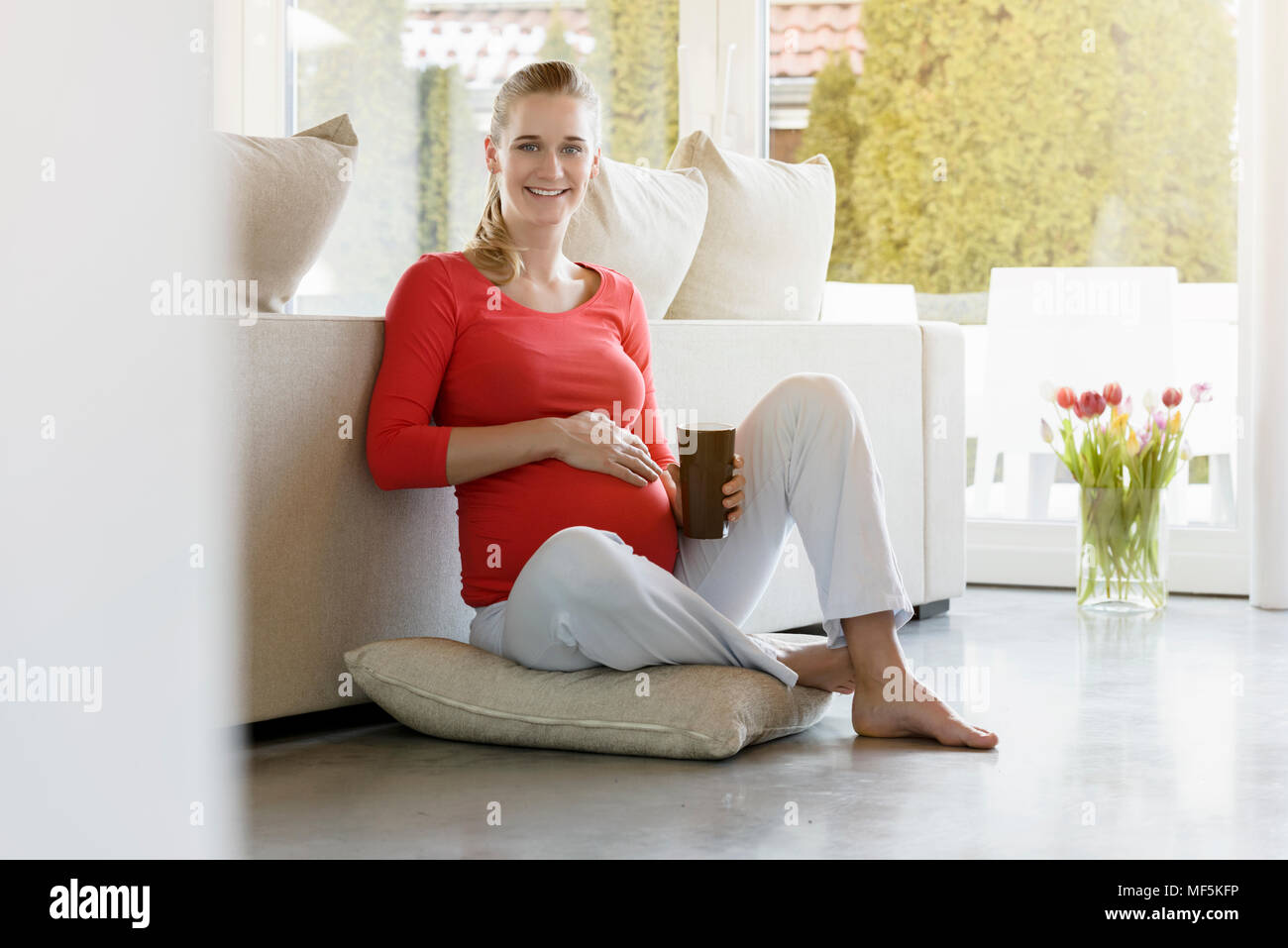 One woman sitting on cushion floor hires stock photography and images