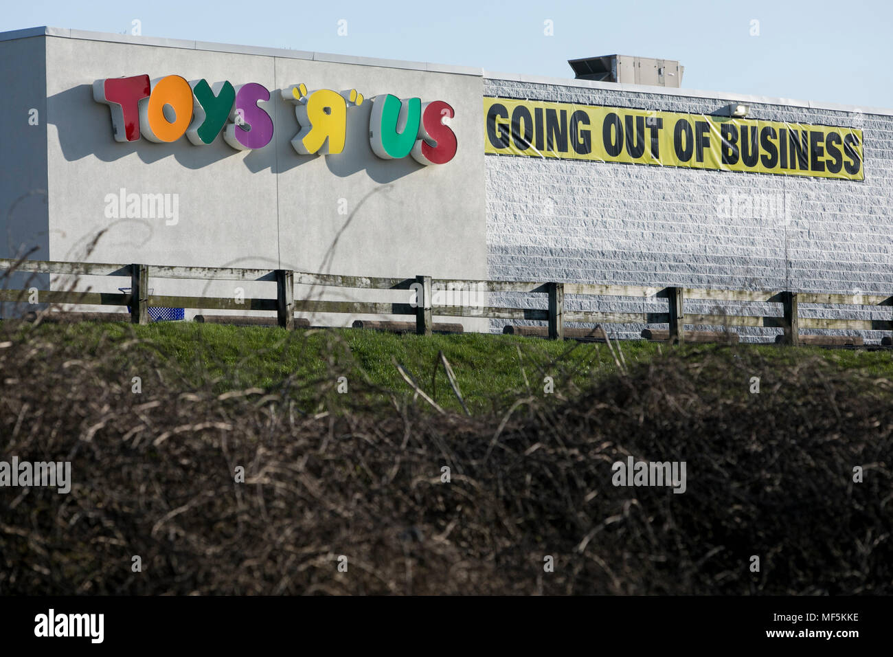 A logo sign outside of a Toys 'R' Us retail store in Lancaster, Pennsylvania with 'Going Out Of Business' and 'Store Closing' signage on April 22, 201 Stock Photo