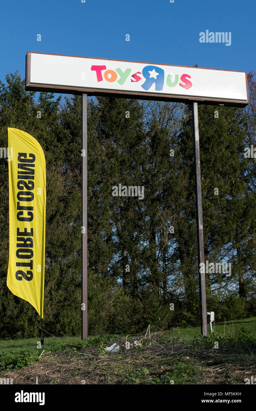 A logo sign outside of a Toys 'R' Us retail store in Lancaster, Pennsylvania with 'Going Out Of Business' and 'Store Closing' signage on April 22, 201 Stock Photo