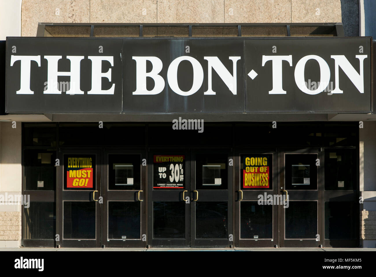 A logo sign outside of a Bon-Ton retail department store in York, Pennsylvania with 'Going Out Of Business' and 'Store Closing' signage on April 22, 2 Stock Photo