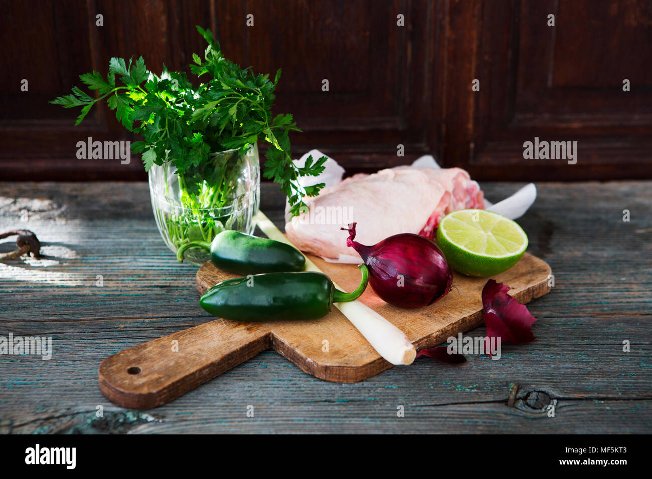 Raw chicken, lemongrass, red onion, lime, parsley, jalapenos Stock Photo