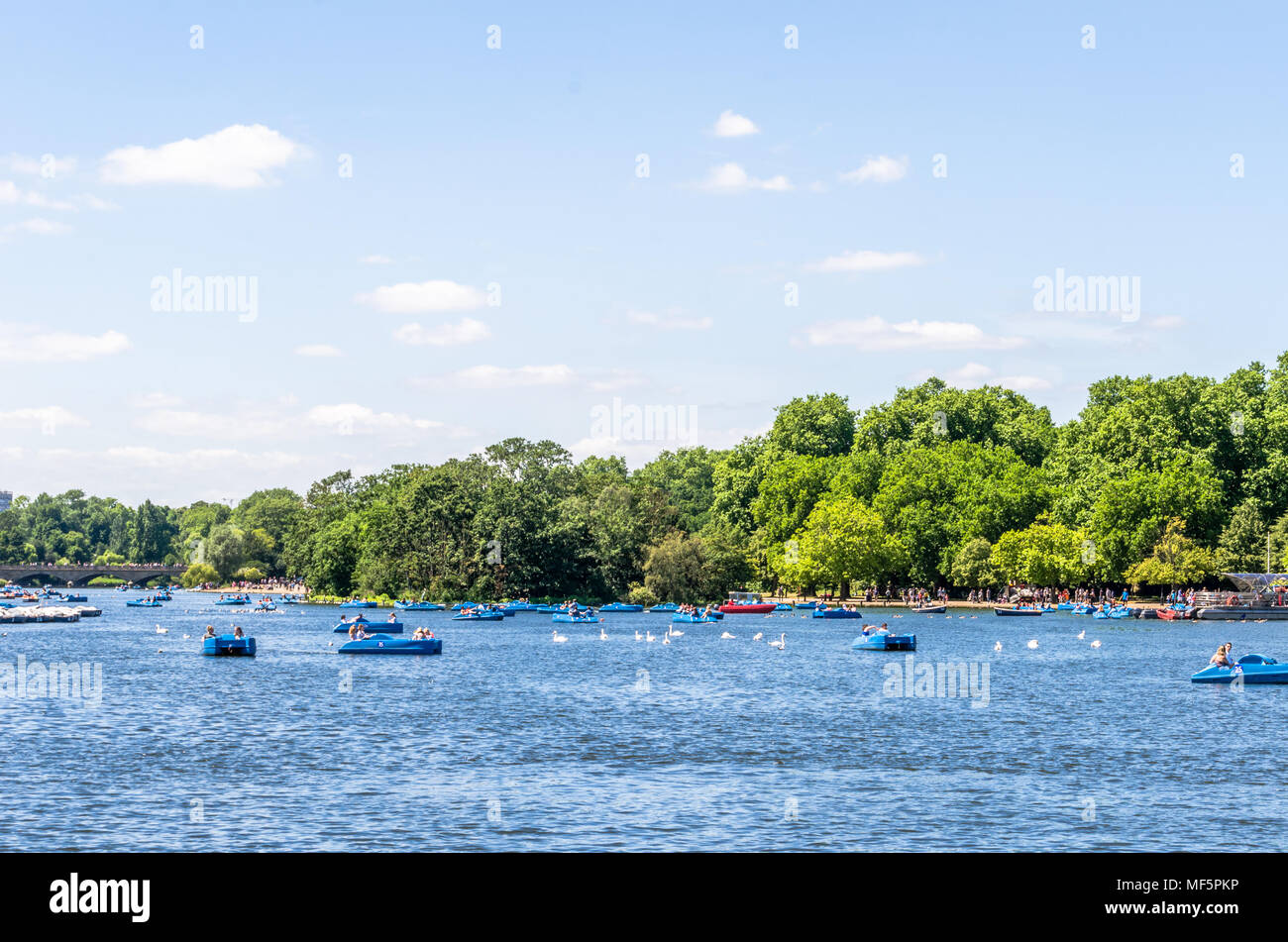 Tourists on recreational boats on the Serperntine at Hyde Park in the City of Westminster, London Stock Photo