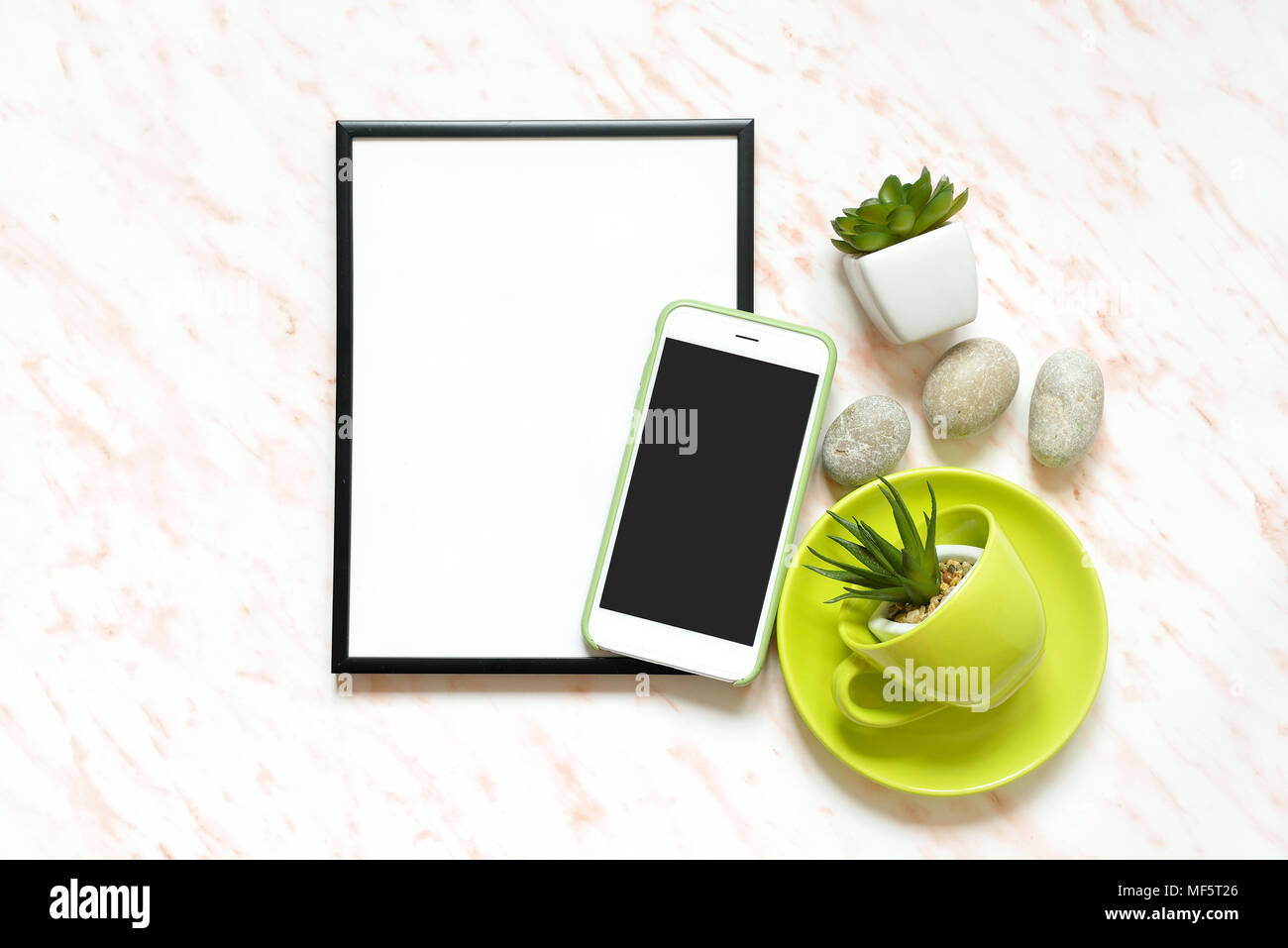 Creative Flat lay marble desk with white empty frame for text, phone, cup, stones and succulents background Stock Photo