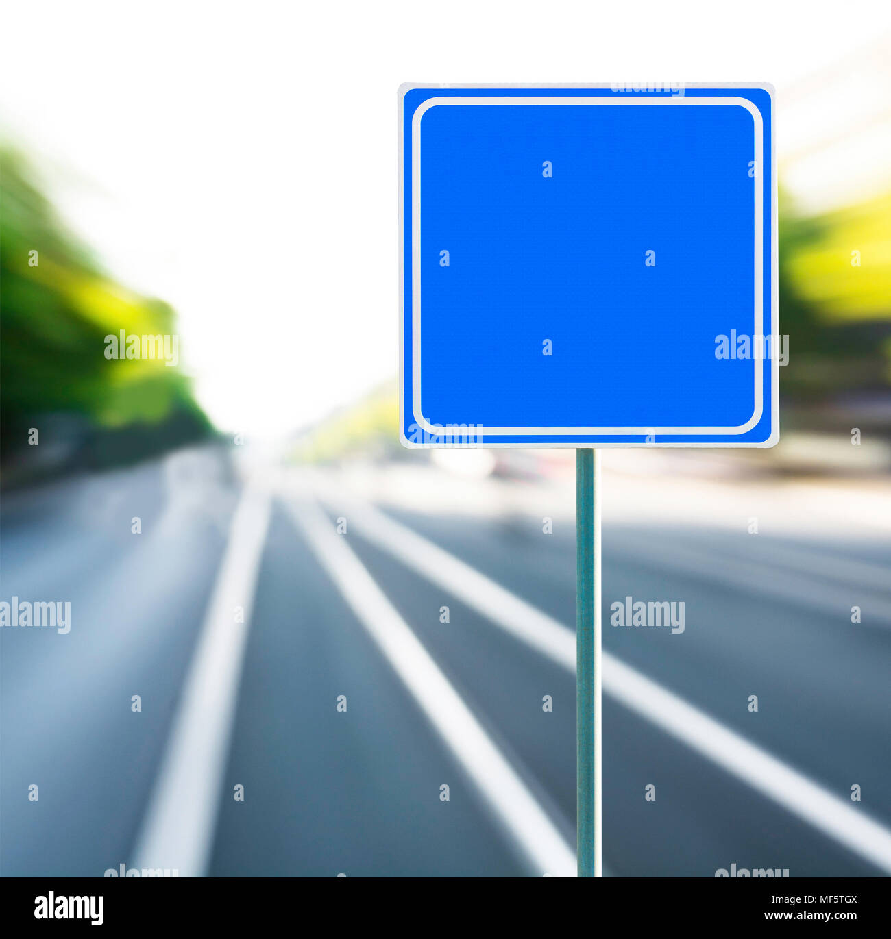 Template, blank, clean blue road sign with blurred speedy background. Copy space. Stock Photo