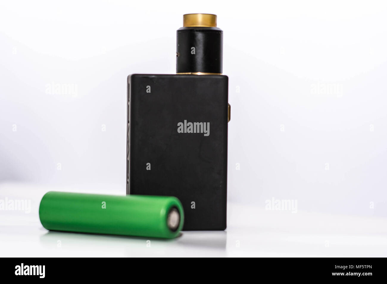 personal vaporizer with battery and q juice or e liquid, green battery and black e ciggaretes with liquid isolated in white background Stock Photo