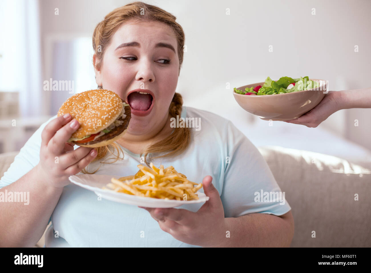 Dreamy young woman admiring green salad Stock Photo