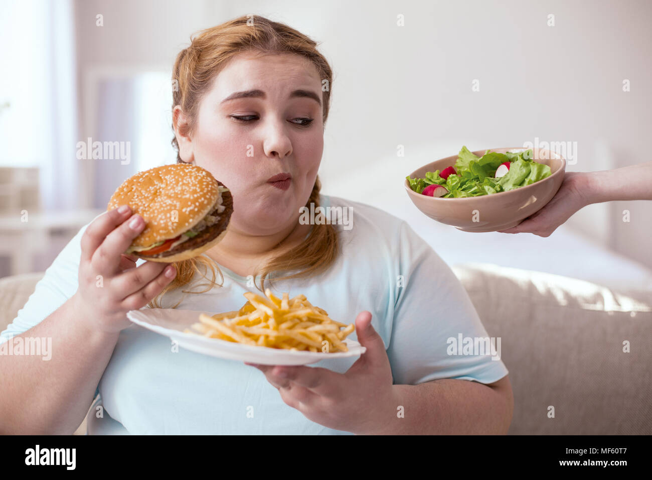 Thoughtful chubby woman making choice Stock Photo