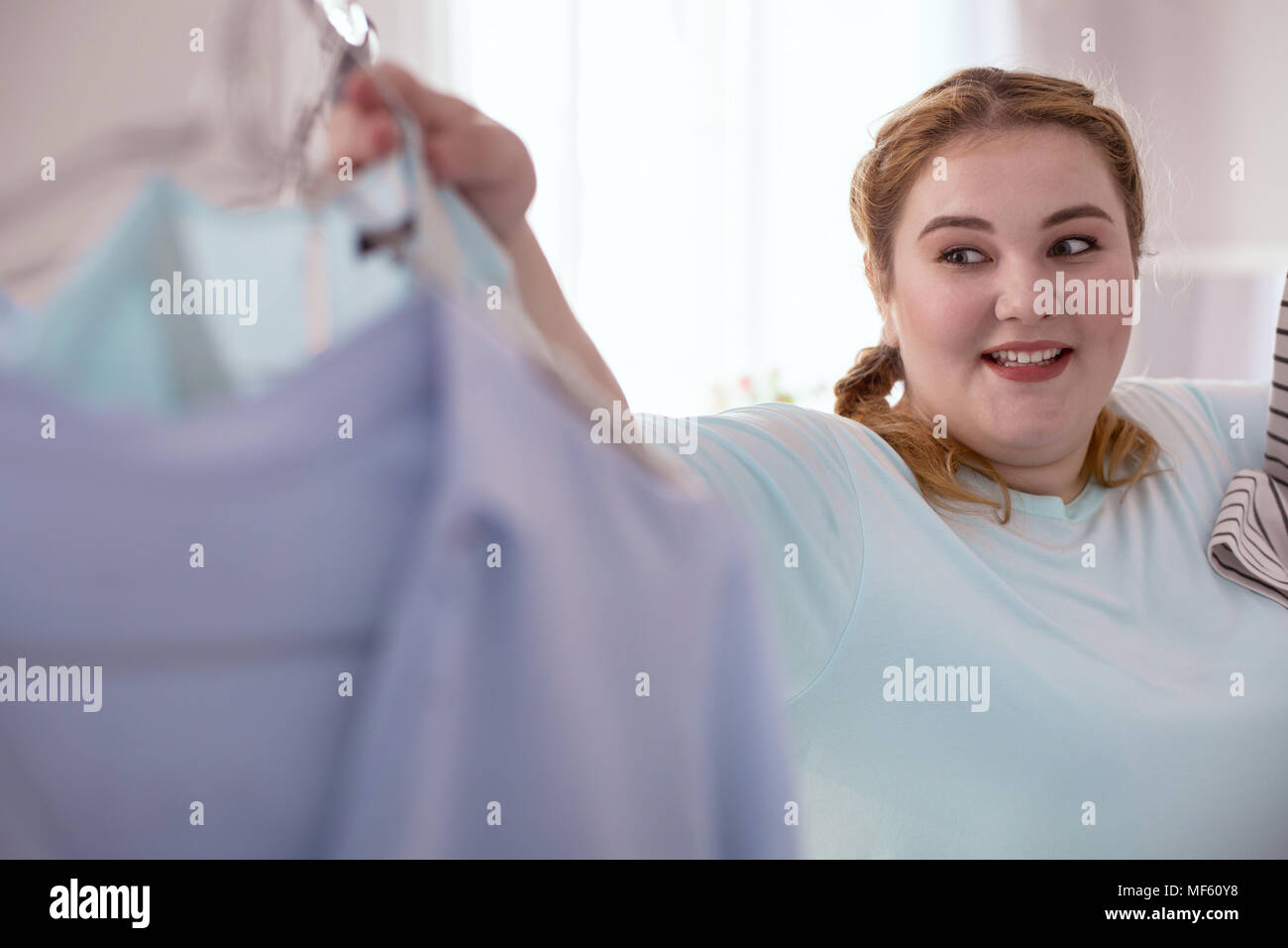 Surprised young woman enjoying her new finding Stock Photo