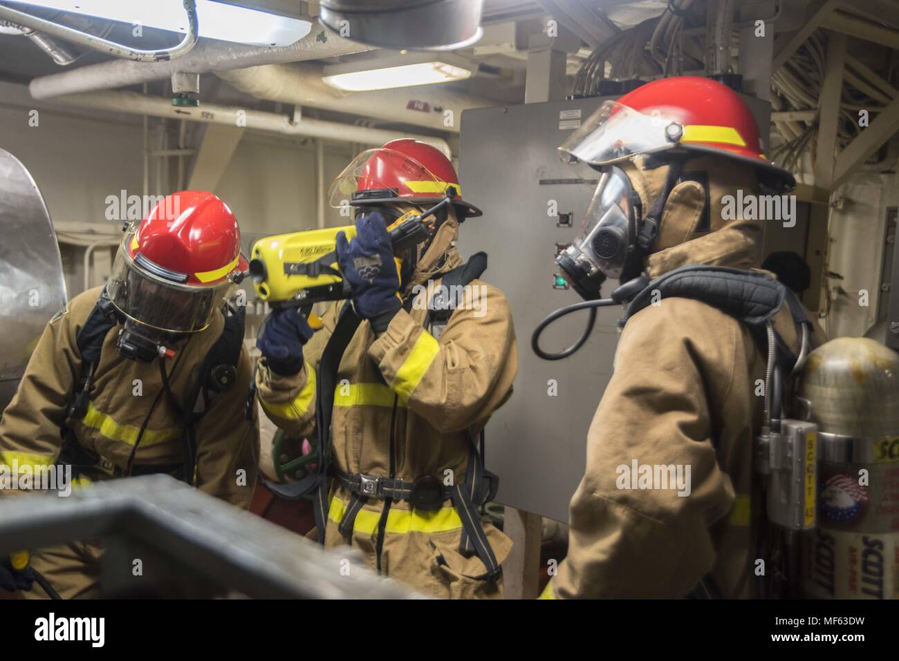 171031-N-DO281-050 ATLANTIC OCEAN (Oct. 31, 2017) Sailors respond to main engine room one during a main space fire drill, aboard the guided-missile cruiser USS Monterey (CG 61), October 31, 2017. Monterey is deployed in support of maritime security operations in the U.S. fifth and sixth fleet area of operations (U.S. Navy photo by Mass Communication Specialist Seaman Trey Fowler). () Stock Photo