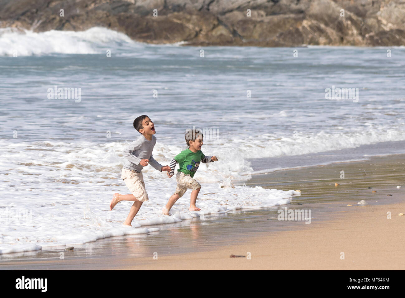 Children on a staycation holiday having fun at the seaside. Stock Photo