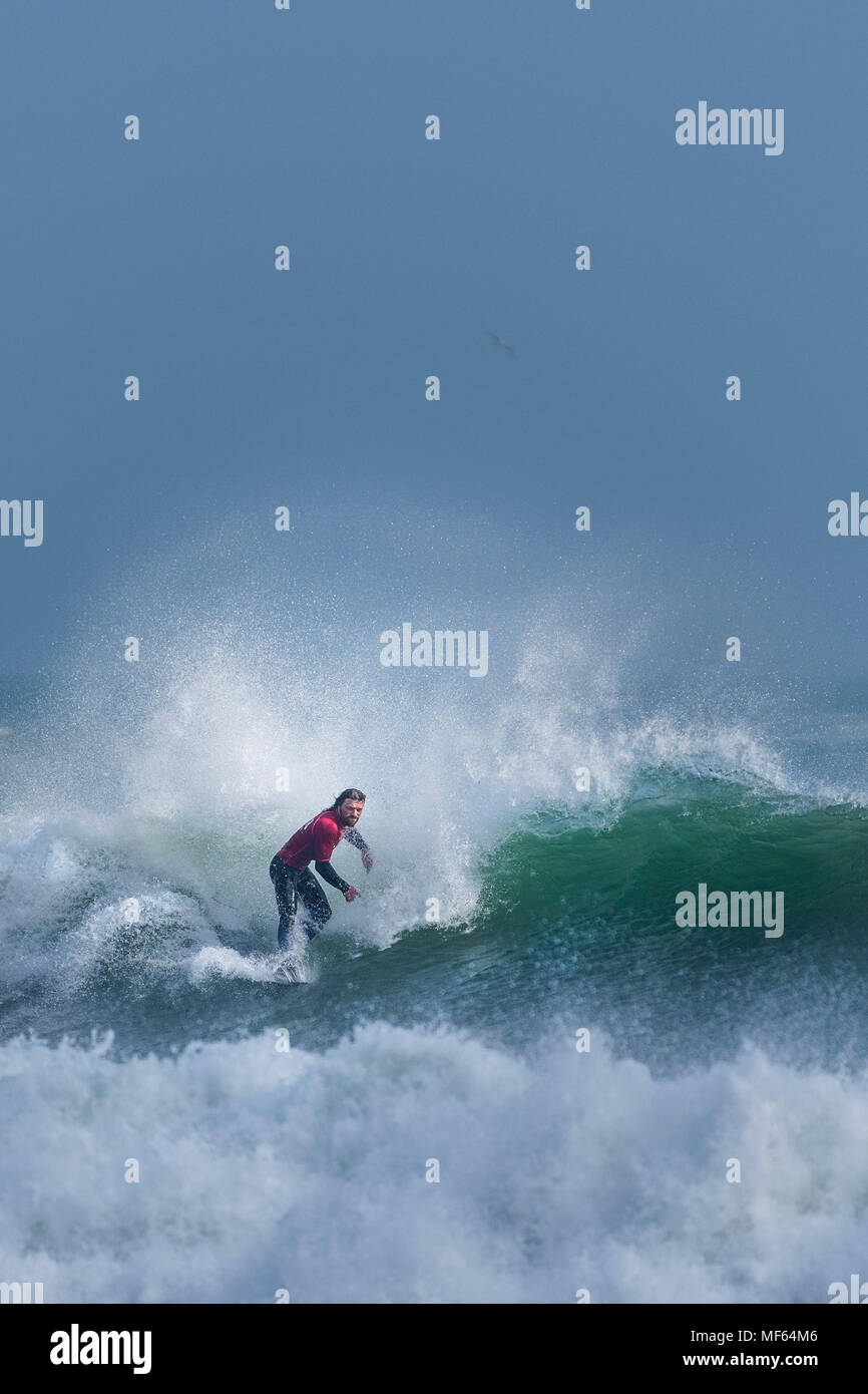 A surfer competing in a longboard surfing competition at Fistral Beach; Newquay Cornwall; Stock Photo