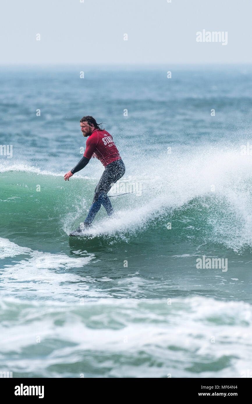 A surfer competing in a longboard surfing competition at Fistral Beach; Newquay Cornwall; Stock Photo