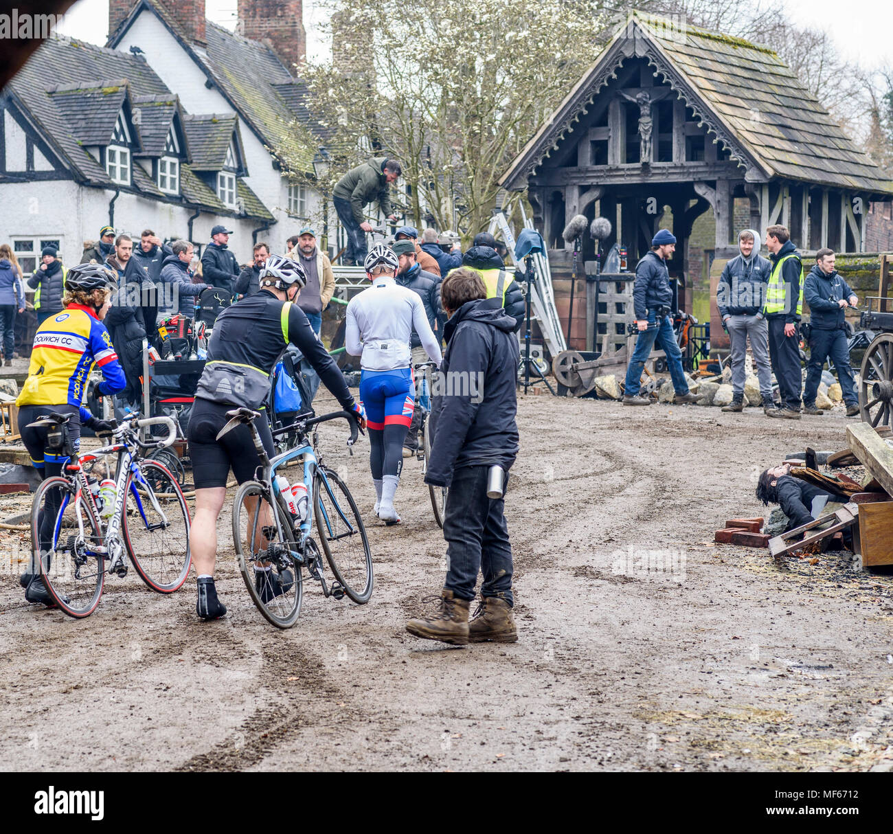 Great Budworth, UK. 11th April, 2018. confused cyclists pass through the set of the new BBC drama 'War Of The Worlds' by HG Wells, being filmed in the Stock Photo