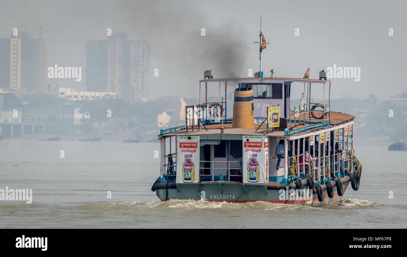Kolkata, India - 4 March 2018:  An isolated view of a ferry crossing river Ganges or Ganga with commuters from the city of Kolkata to Howrah, Kolkata, Stock Photo