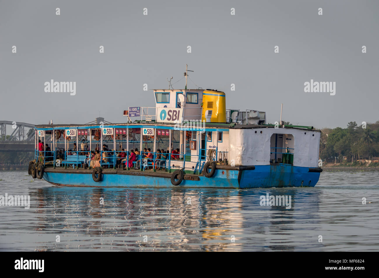 Kolkata, India - 4 March 2018:  An isolated view of a ferry crossing river Ganges or Ganga with commuters from Belur Math to Dakhineswar Temple, Kolka Stock Photo