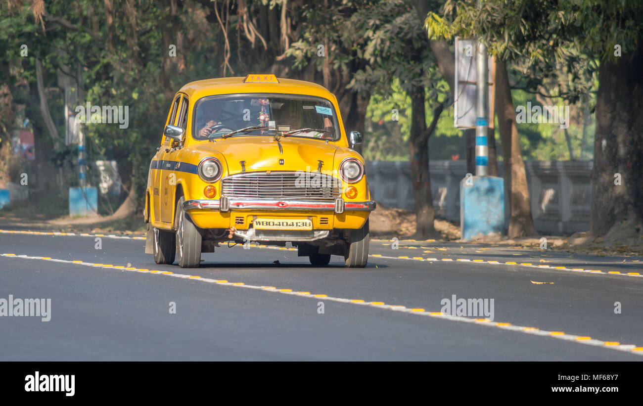 Kolkata, India - March 11th 2018: Iconic yellow Indian taxi in Calcutta (Kolkata) India. The Ambassador taxi is no more built by Hindustan Motors but  Stock Photo