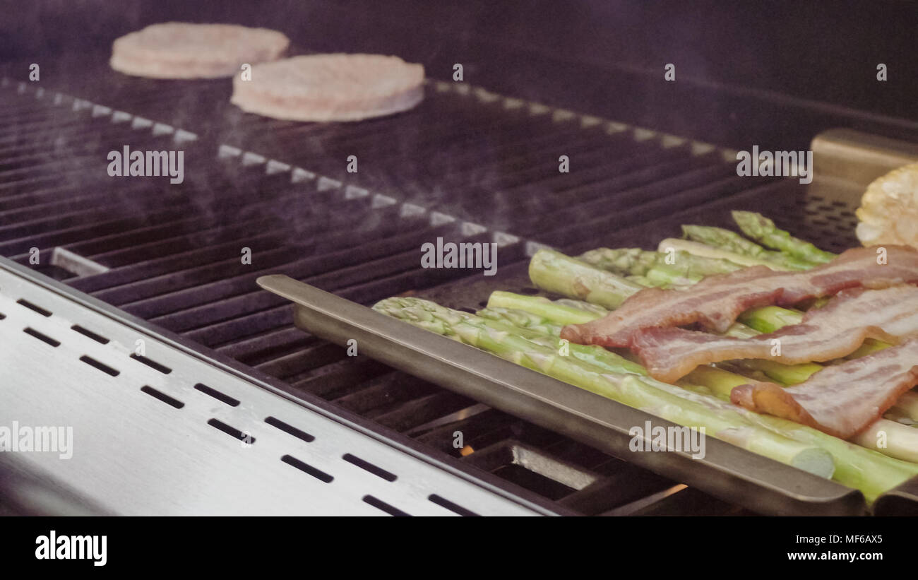 Step by step. Grilling asparagus on outdoor gas grill Stock Photo Alamy