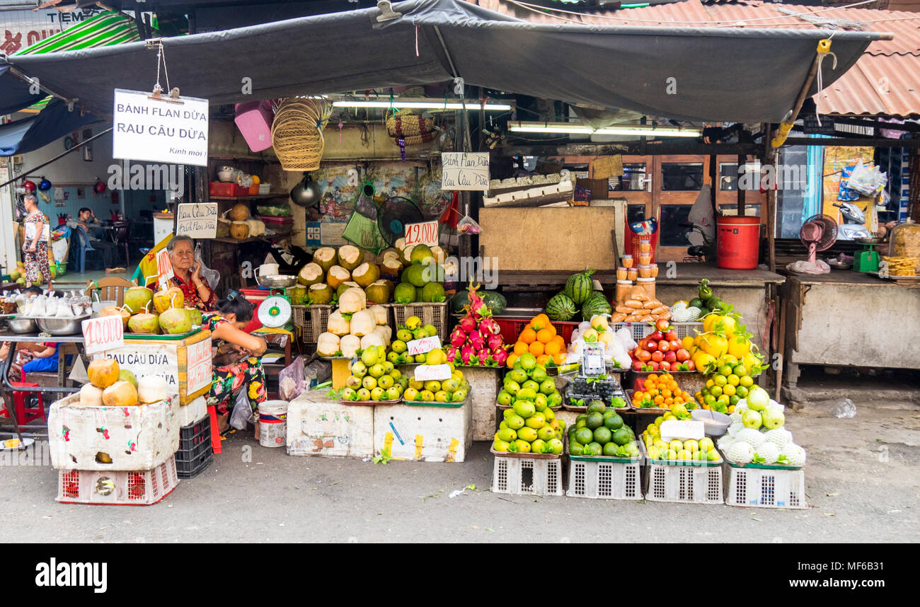 A female shopkeeper in her fruit and market stall in the Ton That Dam Street markets, Ho Chi Minh City, Vietnam. Stock Photo